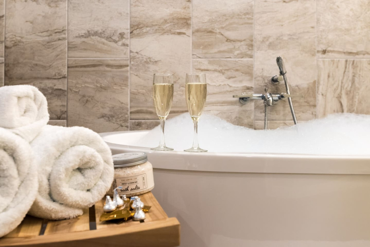 Relax and recharge with a marble deep soak tub in your Lake Travis getaway.