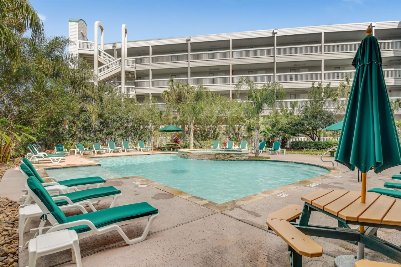 Relax by the heated resort pool just steps from your Galveston condo