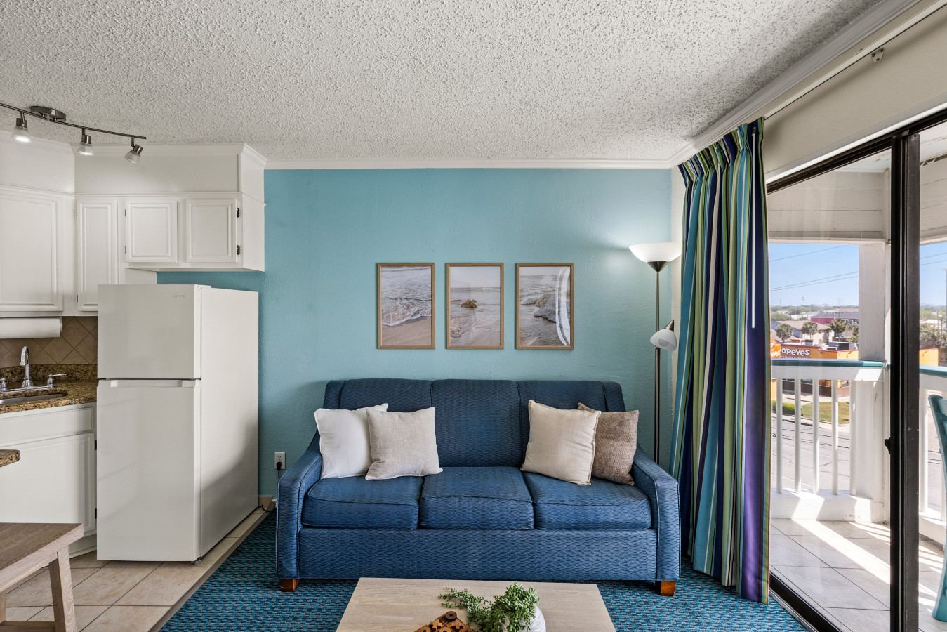 Bright coastal living space with balcony access—perfect for relaxing after a day exploring Galveston.