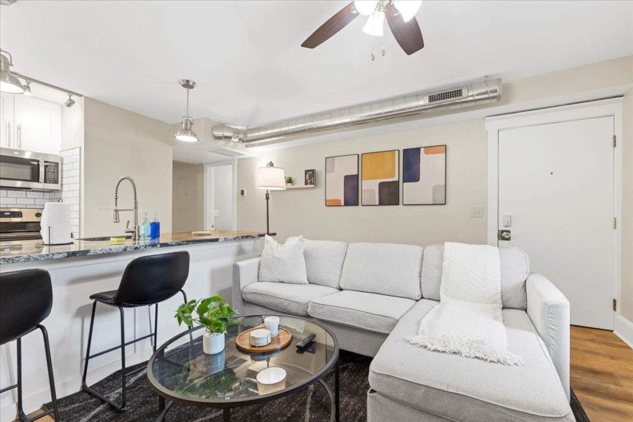 Relax in this warm, inviting space with wooden accents and cozy furnishings. You’ll love unwinding on the plush sofa, enjoying a good book or streaming your favorite shows in a serene atmosphere