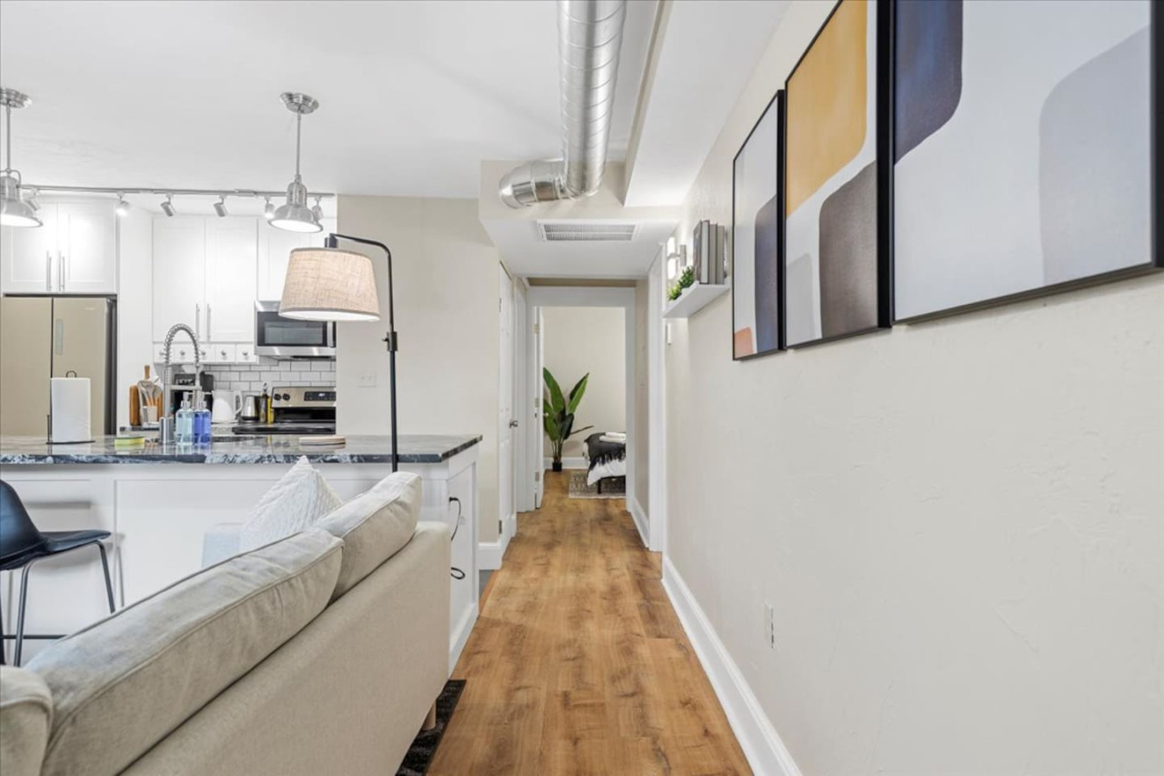 You feel a sense of peace as you step into the living room , with its inviting decor and soothing tones.