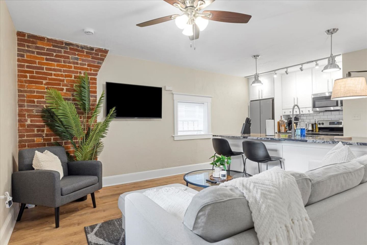 Bright and airy living room with plush seating, a large TV, and tasteful decor, creating the perfect space for relaxation and entertainment.