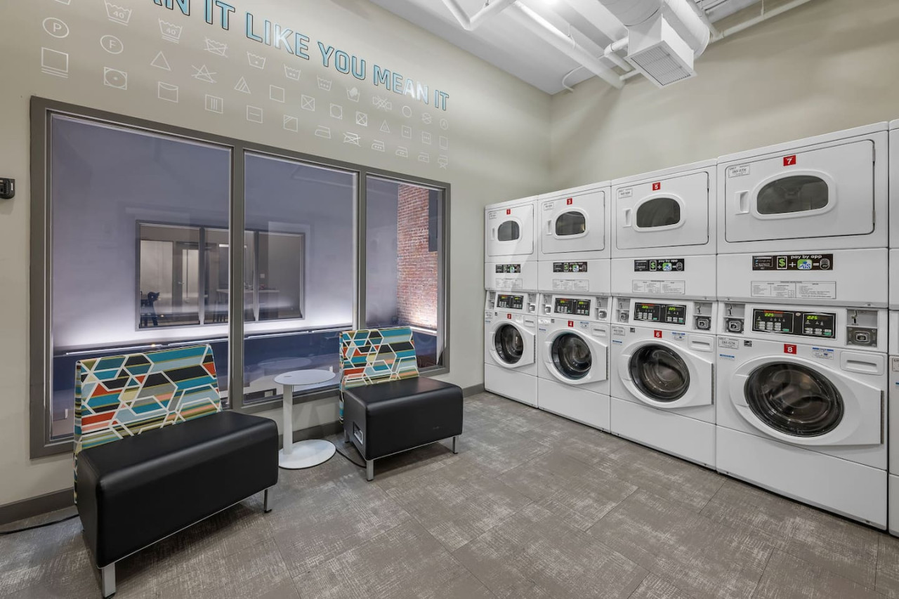 As you step into the laundry room, the modern appliances and ample storage space make it easy to keep things tidy.