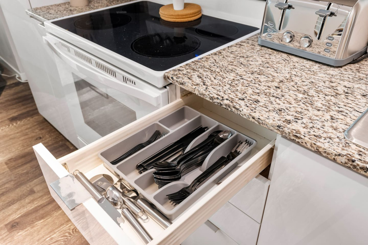 Kitchen cabinets stocked with cooking wares, glassware and silverwares, ideal for mixing up your favorite meals and drinks during your stay.
