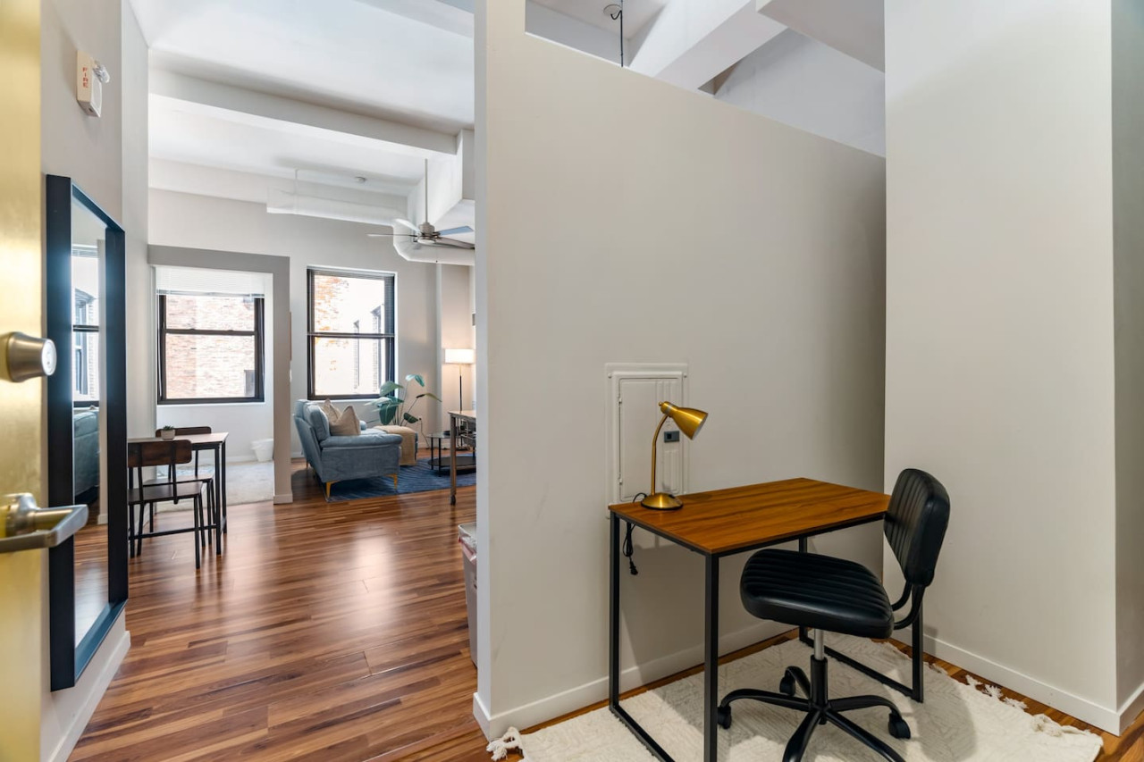 This cozy workspace with warm lighting, and a creative wall display, perfect for productivity.