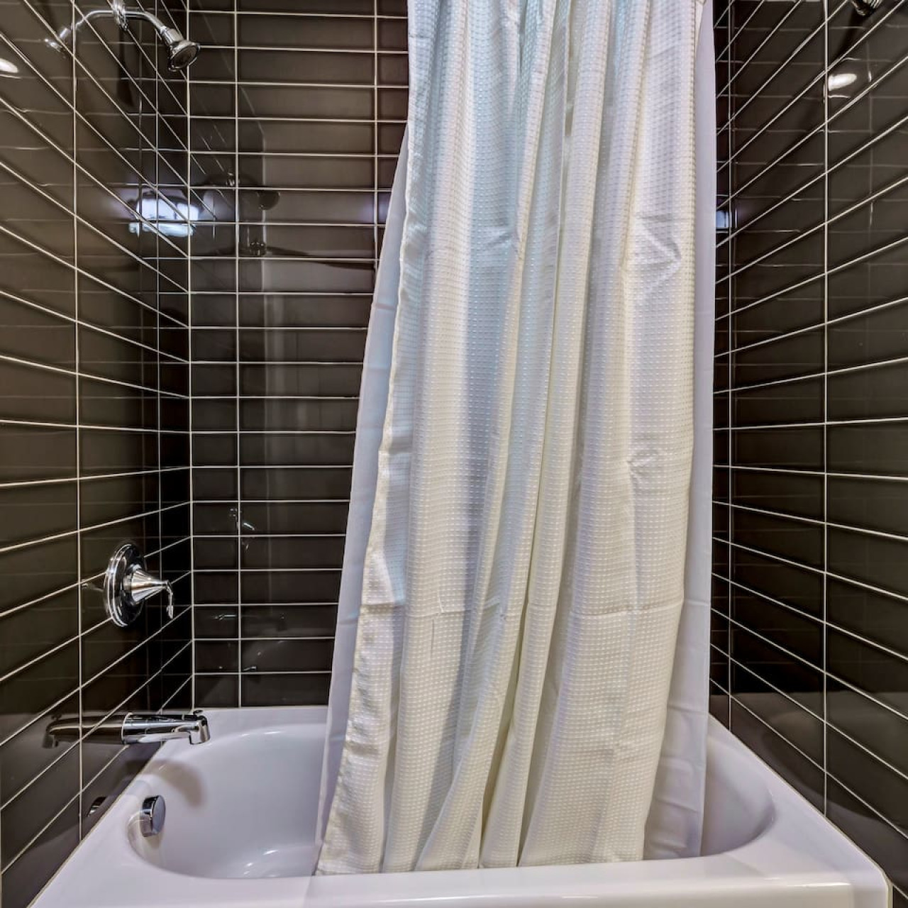 Step into this sparkling clean bathroom, offering you a refreshing retreat. Enjoy a hot shower surrounded by serene forest vibes, and wrap yourself in soft towels after a long day of exploring or relaxing.