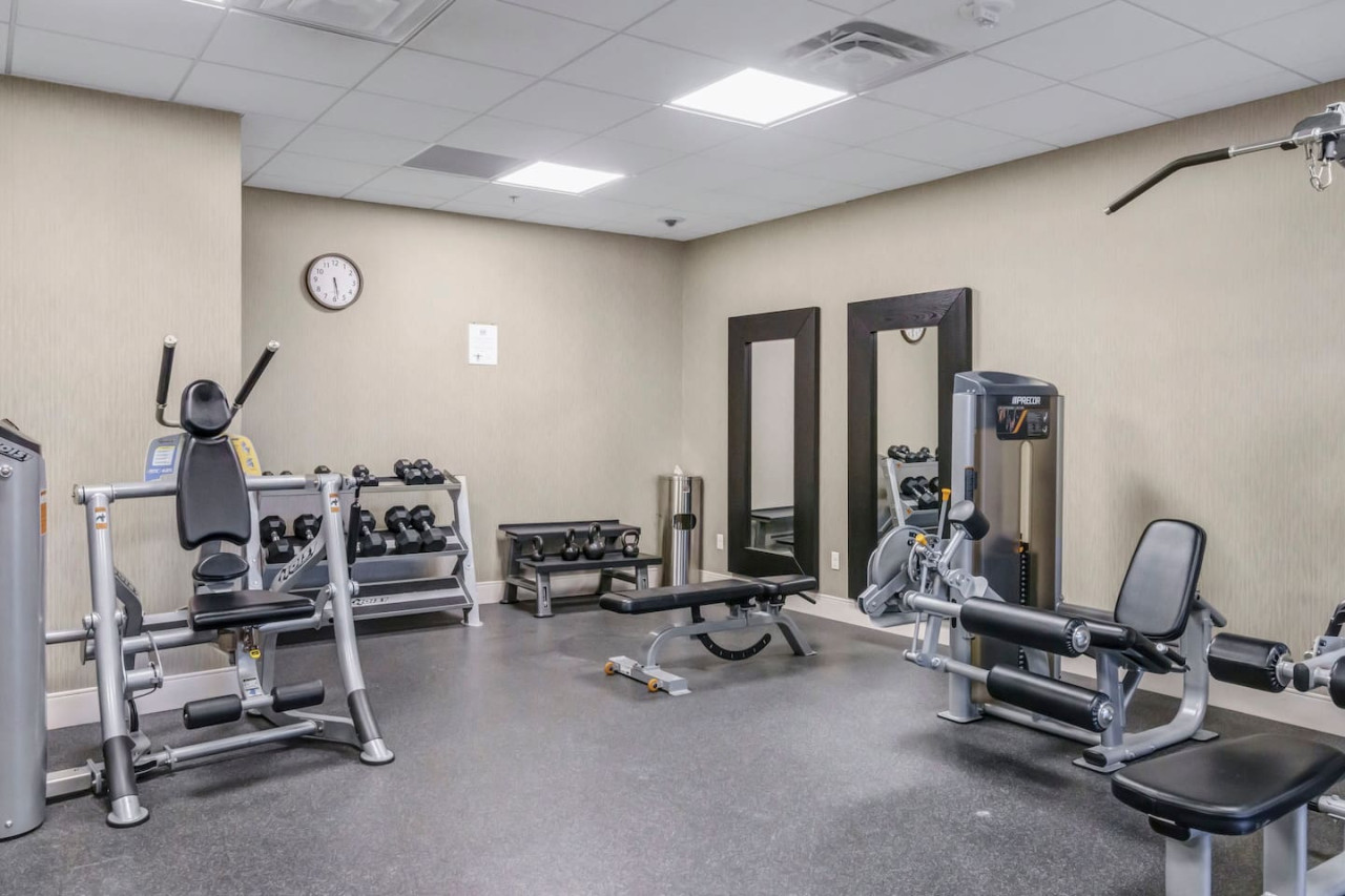 Open floor area with exercise mats, yoga balls, and foam rollers for warm-ups, stretching, or core exercises.