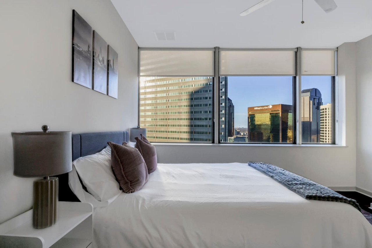 You feel enveloped in comfort as you relax on the queen bed, surrounded by a room designed for tranquility.