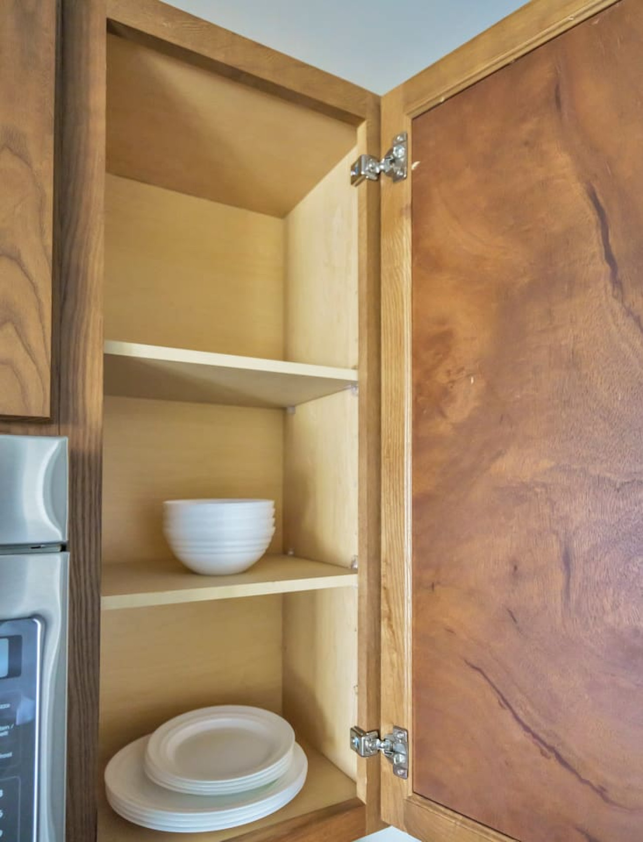 Kitchen cabinets stocked with cooking wares, glassware and silverwares, ideal for mixing up your favorite meals and drinks during your stay.