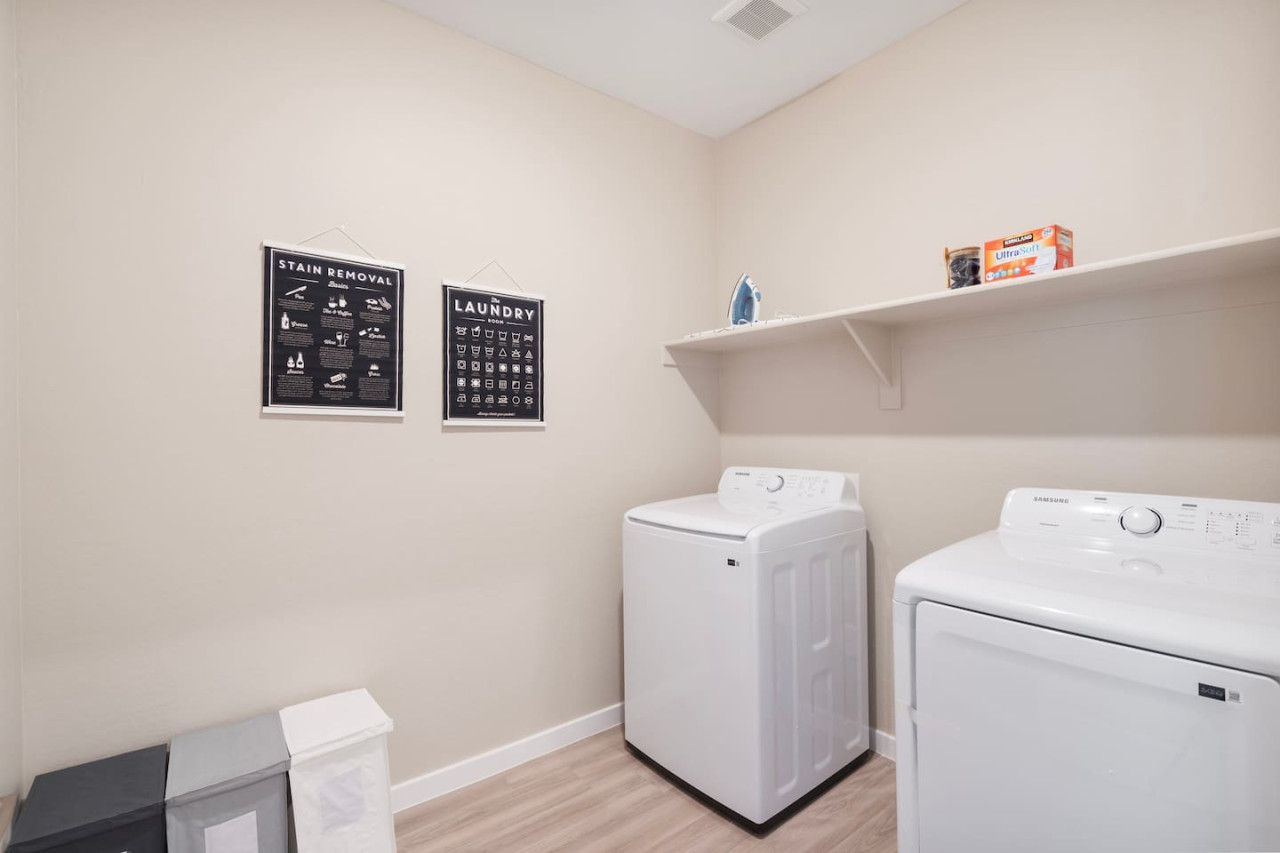 As you step into the laundry room, the modern appliances and ample storage space make it easy to keep things tidy.