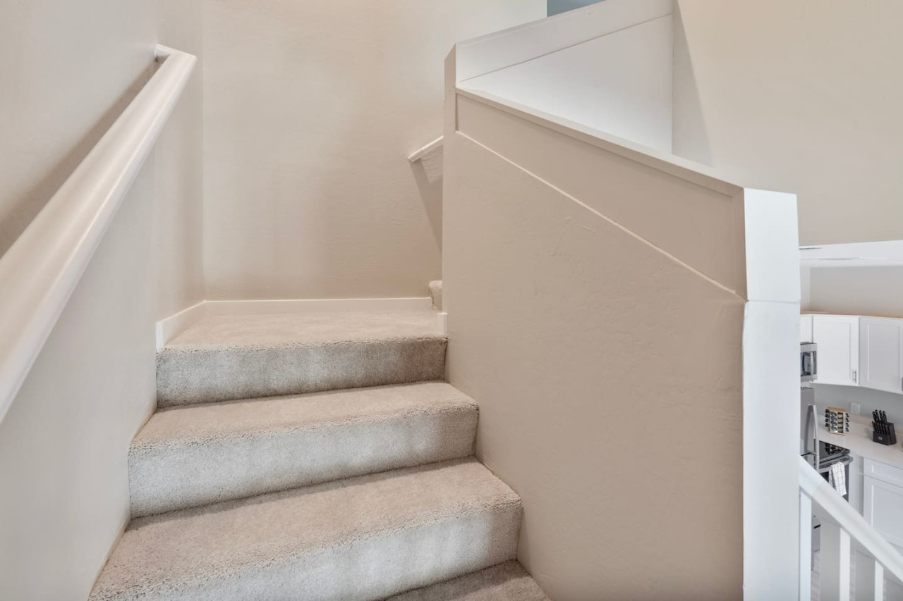 The staircase is a focal point of the home, with its graceful lines and stylish details adding to the overall charm.