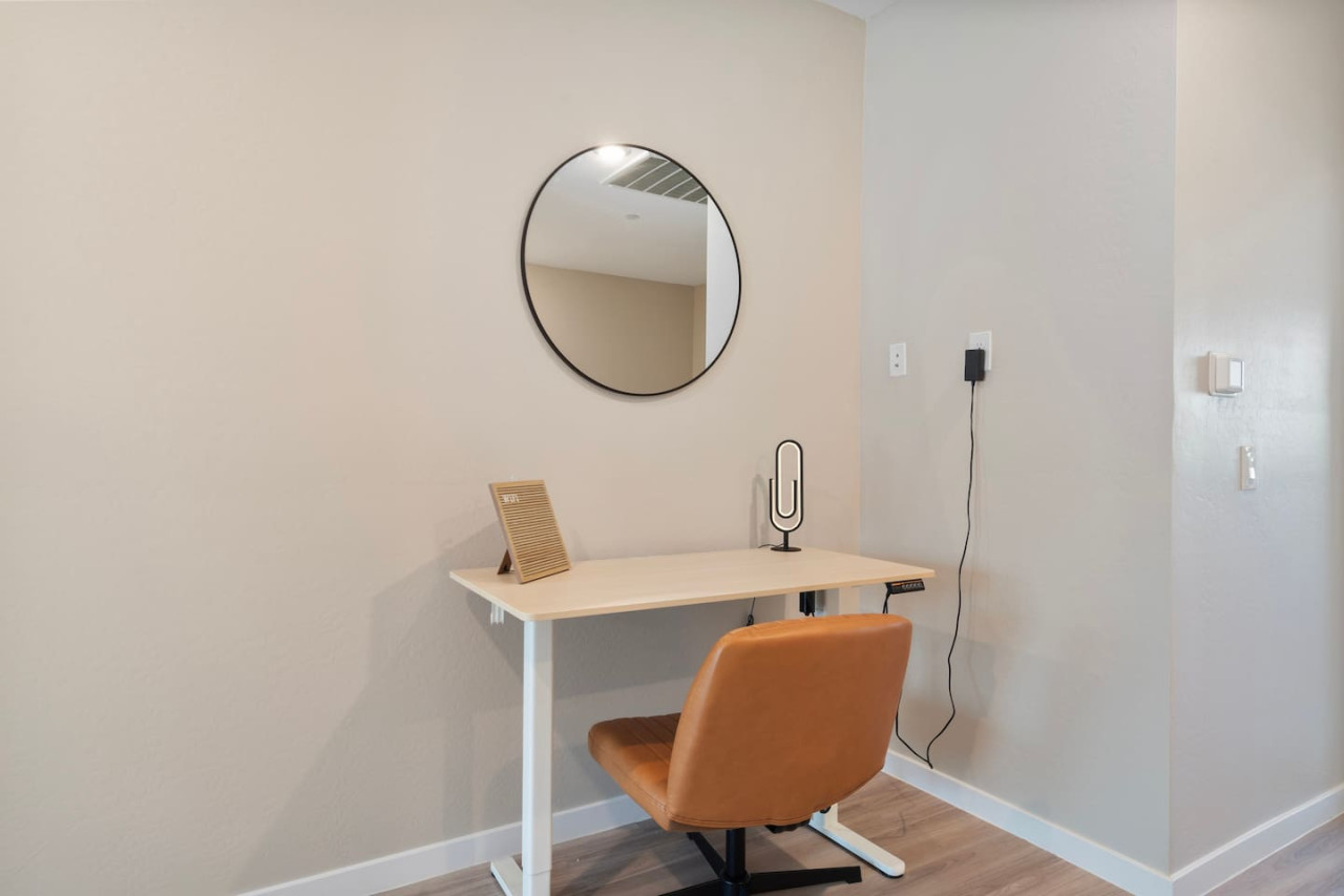This cozy workspace with warm lighting, and a creative wall display, perfect for productivity.