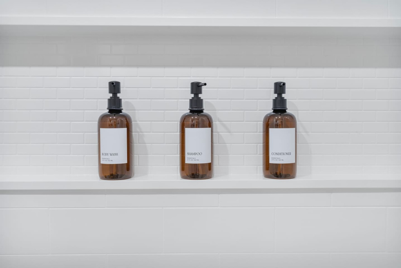 Immaculate bathroom featuring a spacious shower, fresh towels, and complimentary toiletries for a spa-like experience.