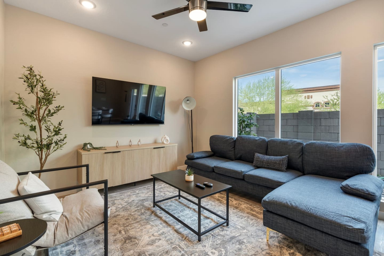 Bright and airy living room with plush seating, a large TV, and tasteful decor, creating the perfect space for relaxation and entertainment.