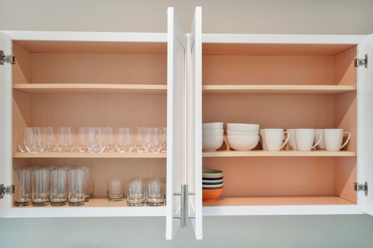 Kitchen cabinets stocked with cooking wares, glassware and silverwares, ideal for mixing up your favorite meals and drinks during your stay.