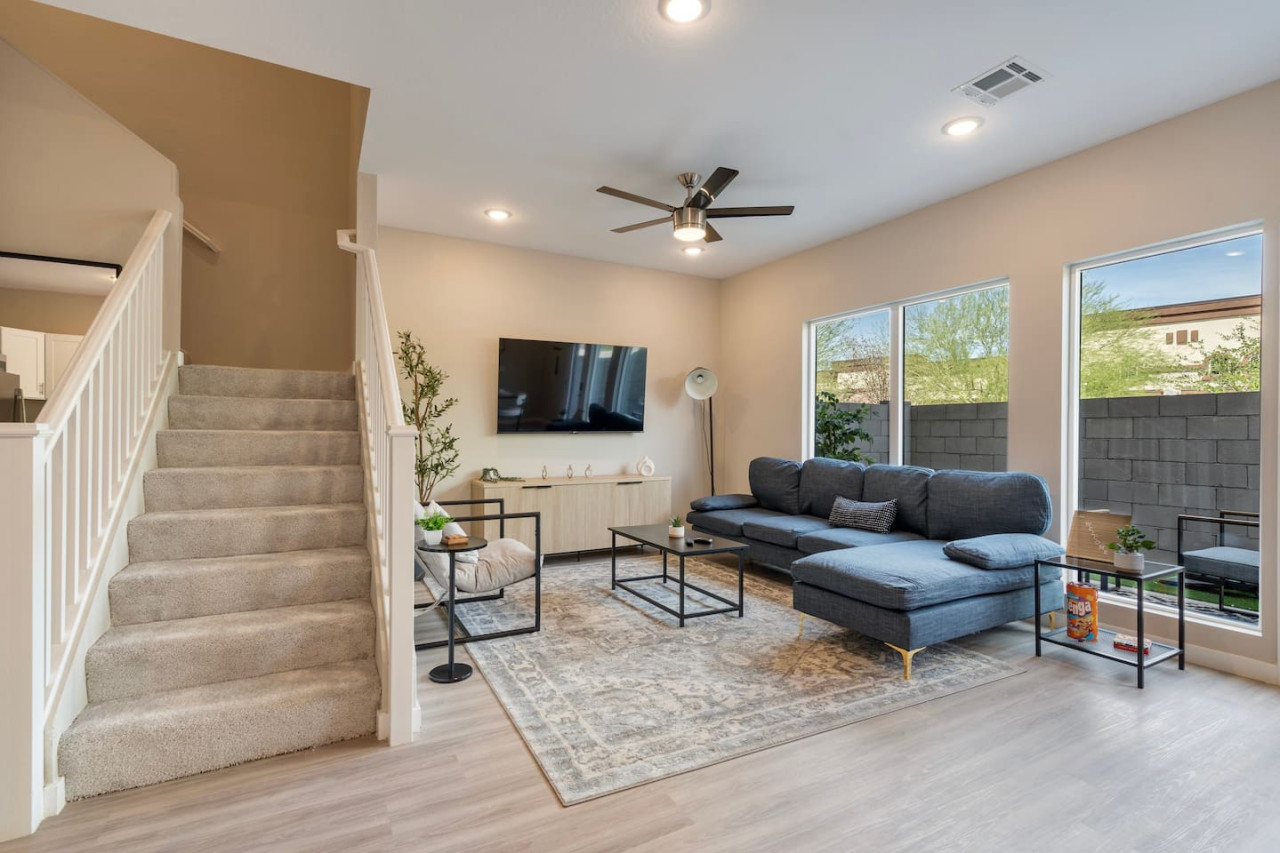 The staircase is a focal point of the home, with its graceful lines and stylish details adding to the overall charm.