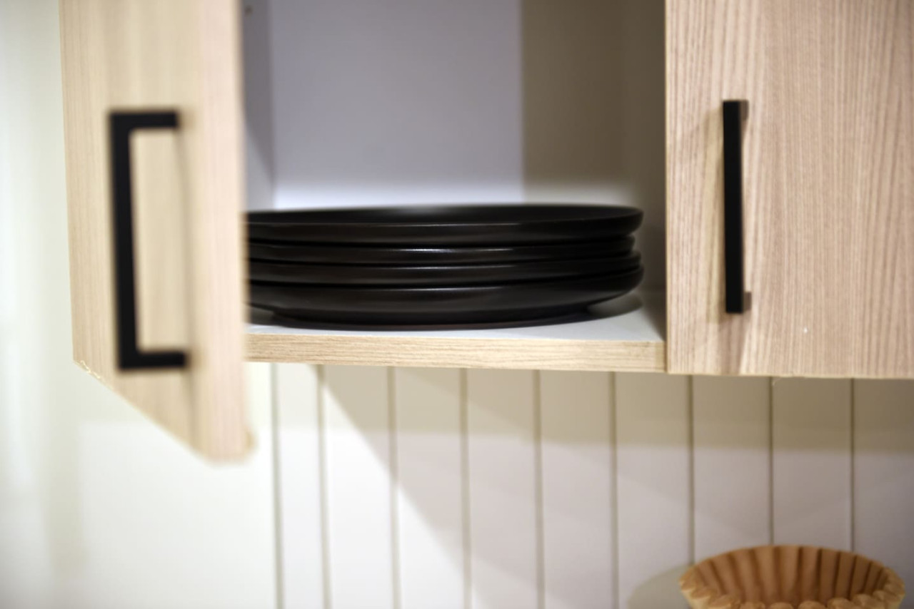 Kitchen cabinets stocked with cooking wares, glassware and silverwares, ideal for mixing up your favorite meals and drinks during your stay.