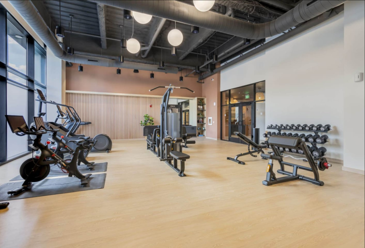 Open floor area with exercise mats, yoga balls, and foam rollers for warm-ups, stretching, or core exercises.