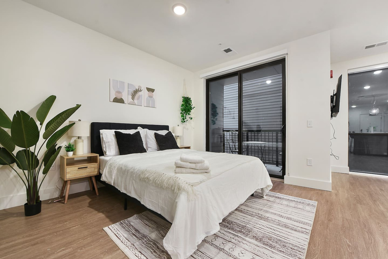You feel enveloped in comfort as you relax on the queen bed, surrounded by a room designed for tranquility.