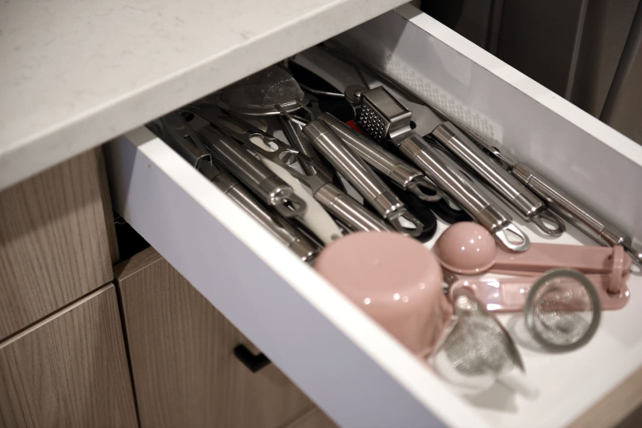 Kitchen cabinets stocked with cooking wares, glassware and silverwares, ideal for mixing up your favorite meals and drinks during your stay.