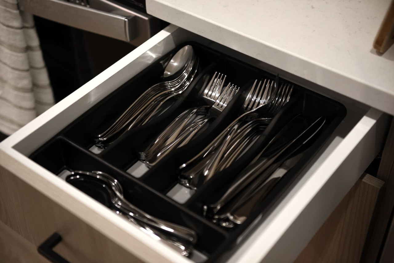 Kitchen cabinets stocked with cooking wares, glassware and silverwares, ideal for mixing up your favorite meals and drinks during your stay.