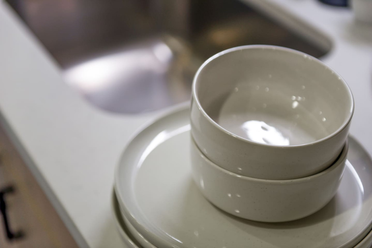 Kitchen cabinets stocked with cooking wares, glassware and silverwares, ideal for mixing up your favorite meals and drinks during your stay.