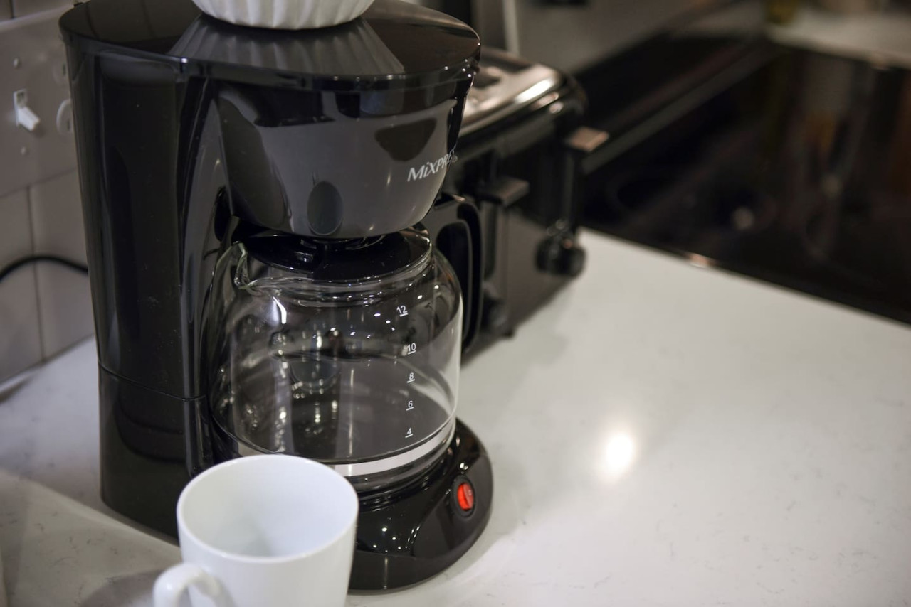 The coffee station is thoughtfully equipped with a variety of in-house consumables, including a selection of ground coffee, sweeteners, and creamers to suit every taste.