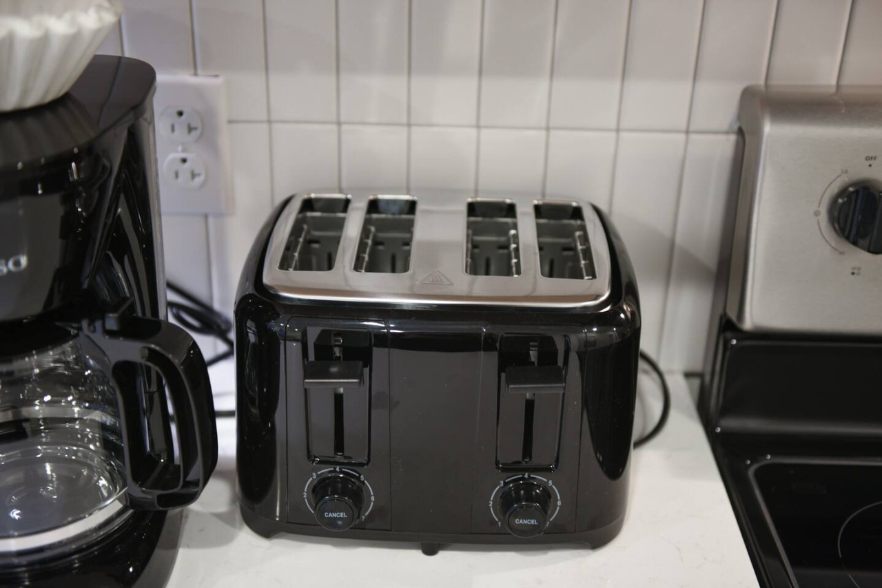 The coffee station is thoughtfully equipped with a variety of in-house consumables, including a selection of ground coffee, sweeteners, and creamers to suit every taste.