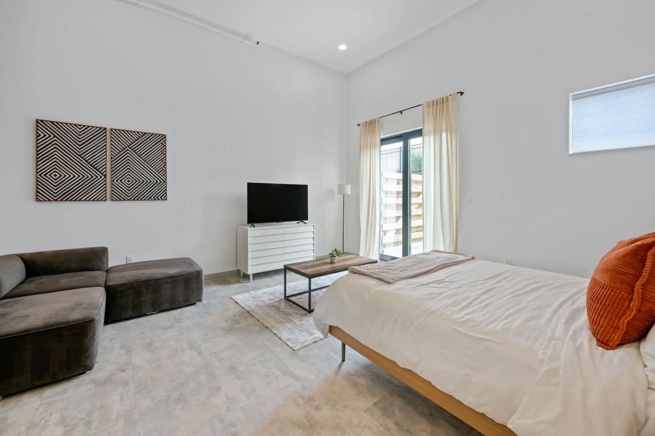 You feel enveloped in comfort as you relax on the queen bed, surrounded by a room designed for tranquility.