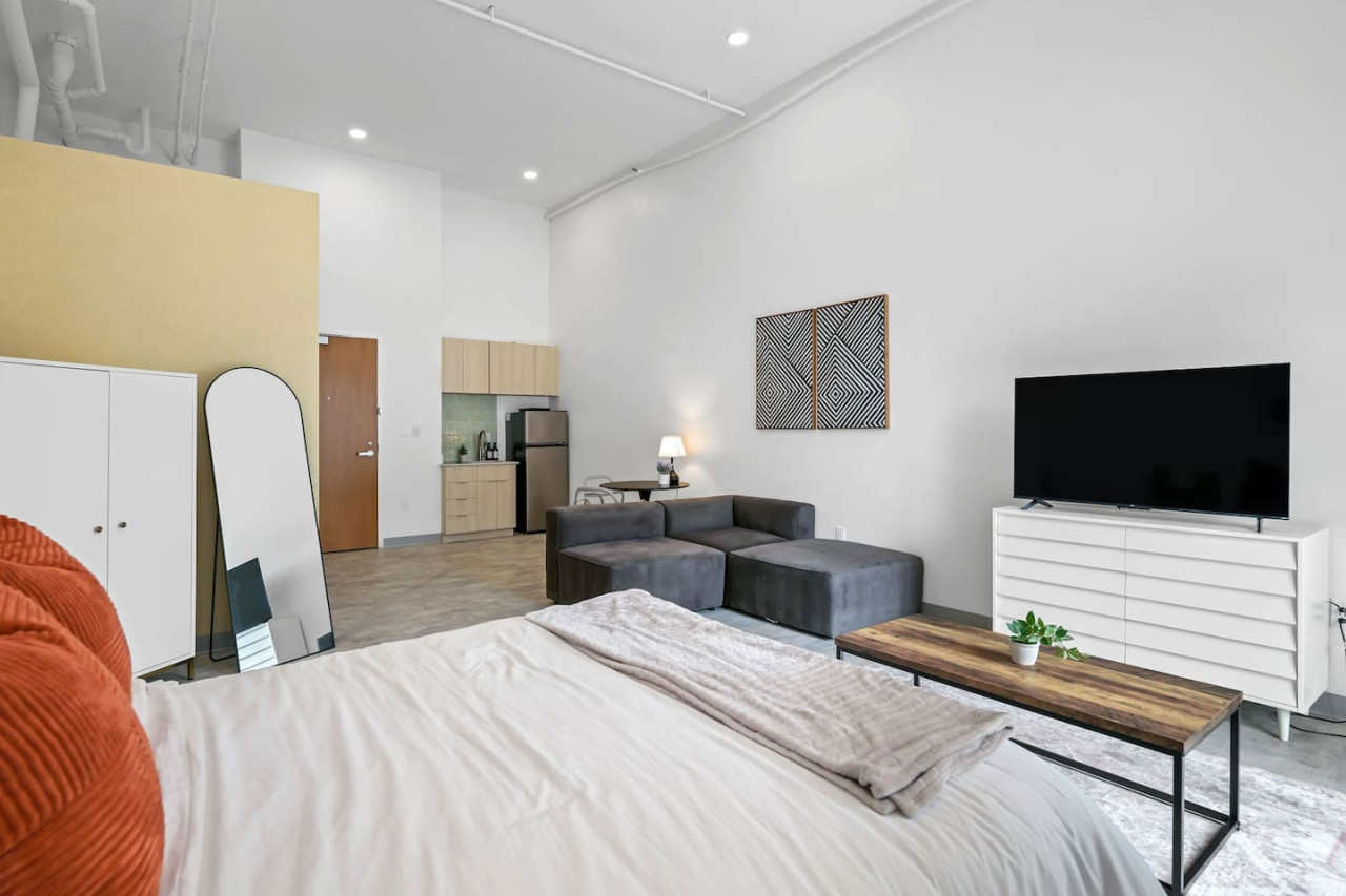 You feel enveloped in comfort as you relax on the queen bed, surrounded by a room designed for tranquility.
