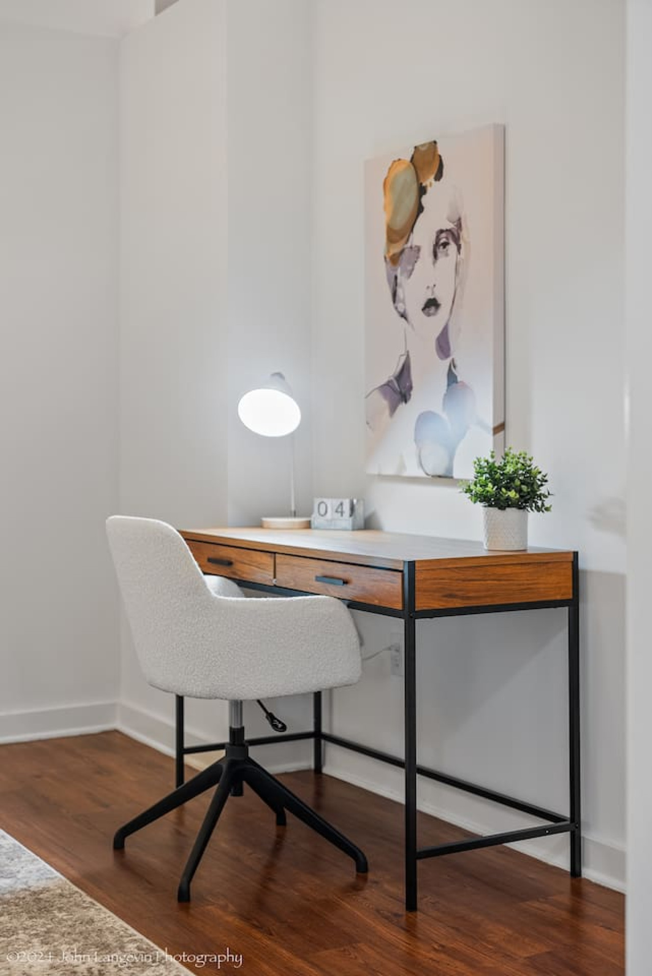 This cozy workspace with warm lighting, and a creative wall display, perfect for productivity.