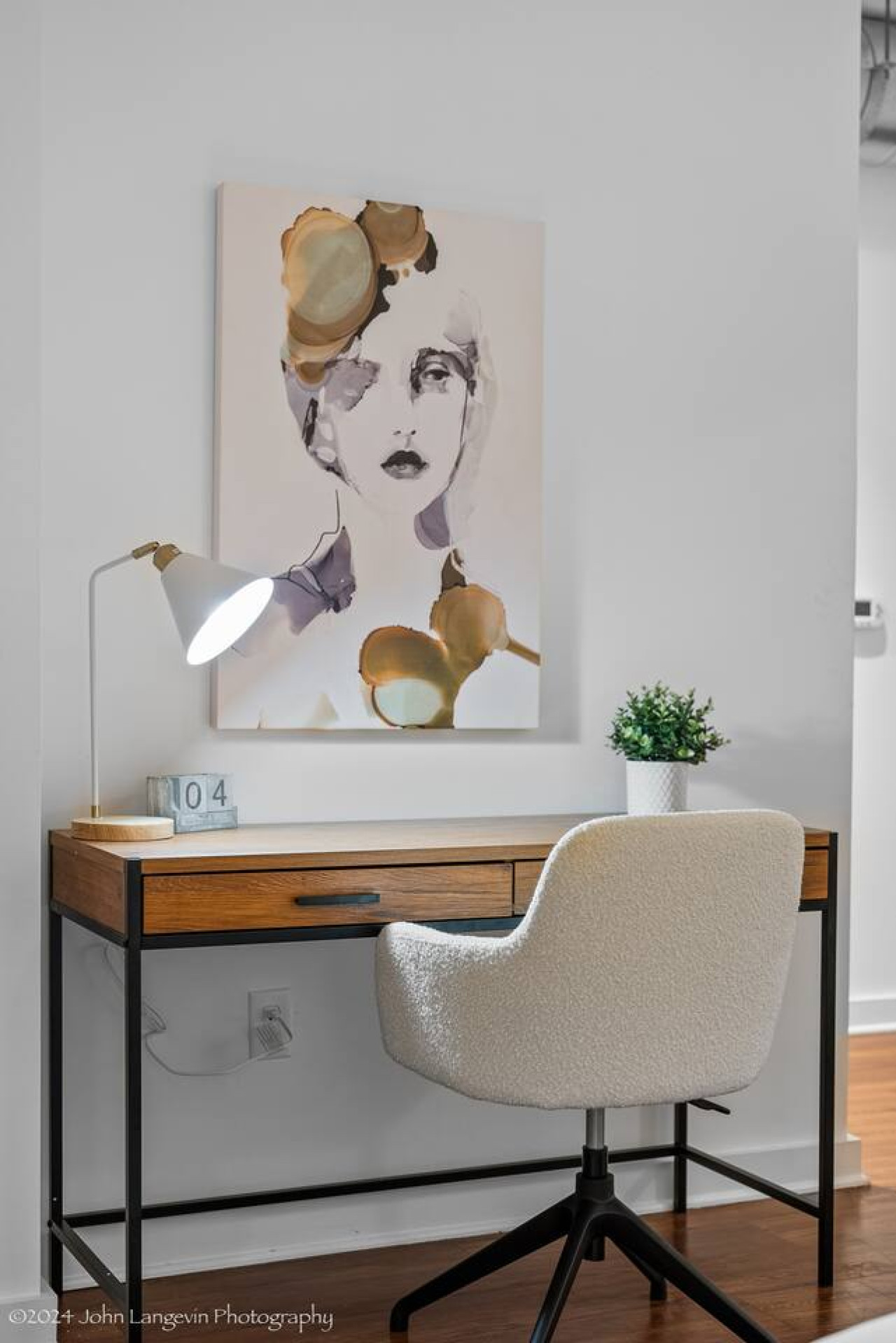 This cozy workspace with warm lighting, and a creative wall display, perfect for productivity.