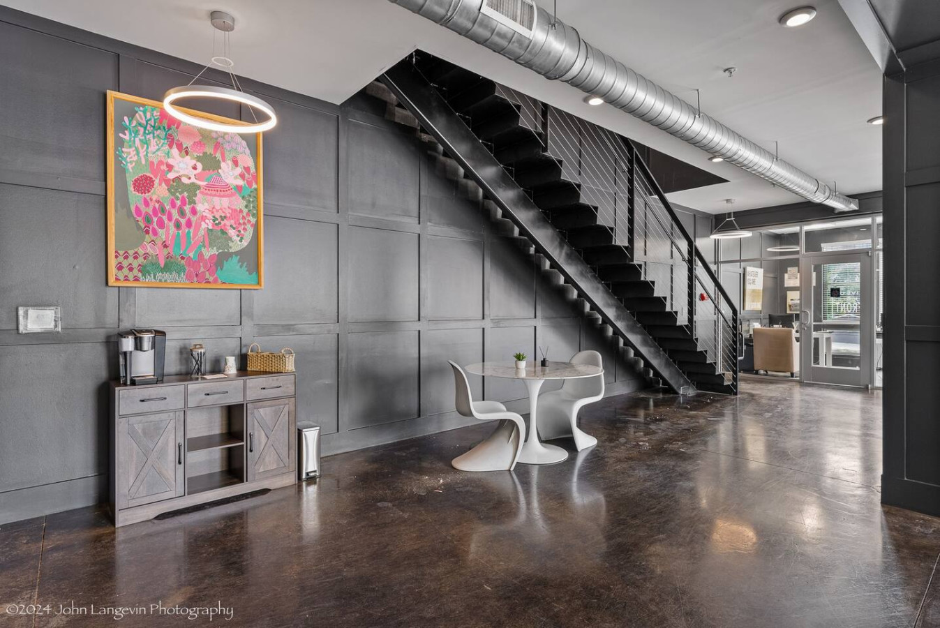 The staircase is a focal point of the home, with its graceful lines and stylish details adding to the overall charm.