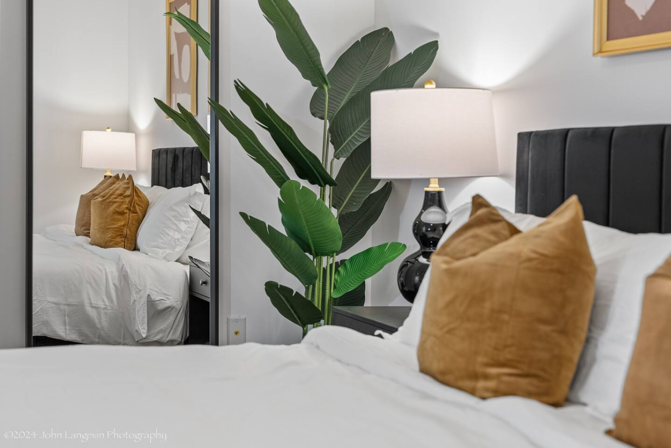 Retreat to the cozy master bedroom featuring a luxurious king-size bed with plush pillows, modern decor, blackout curtains, and a convenient workspace for all your needs.