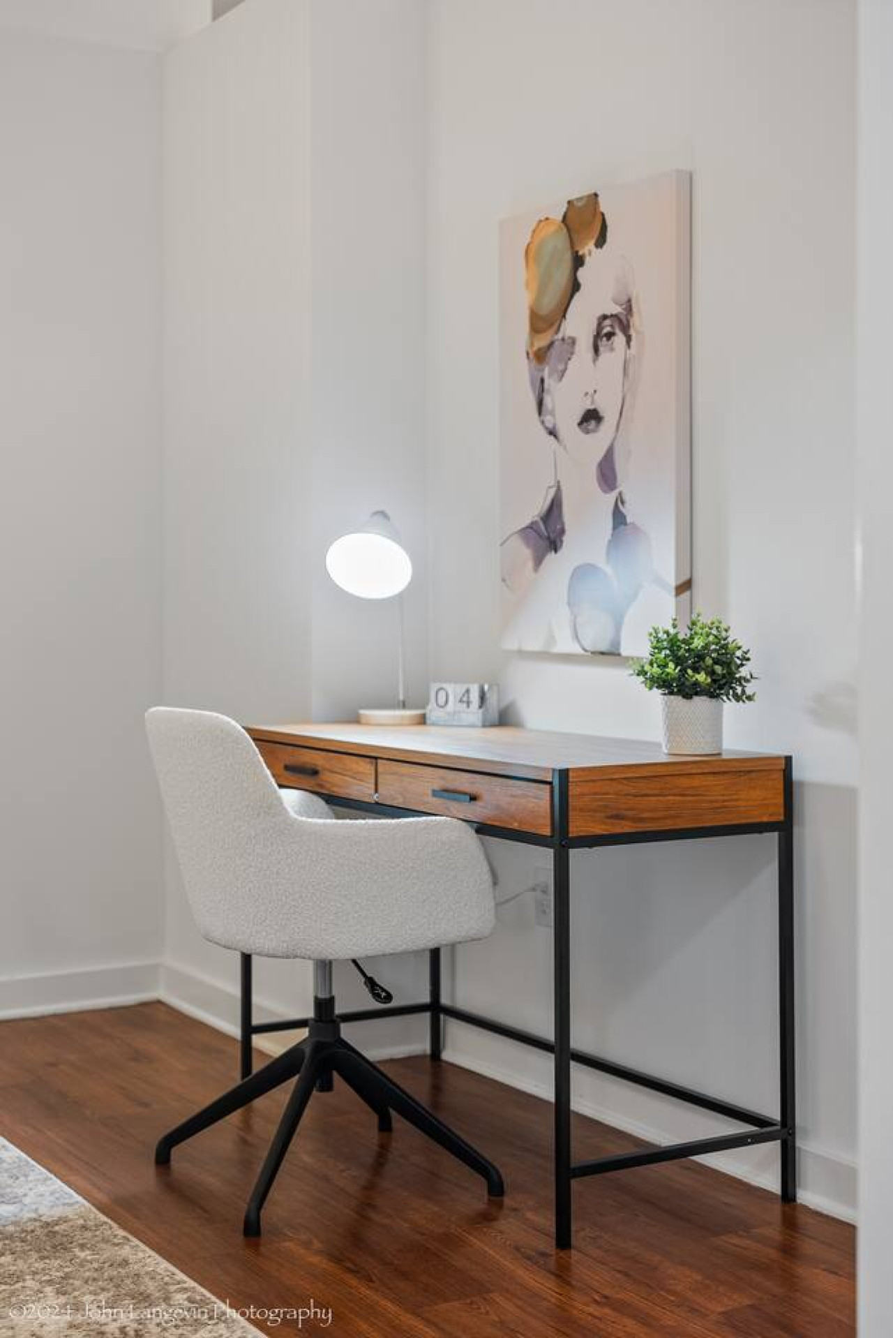 This cozy workspace with warm lighting, and a creative wall display, perfect for productivity.