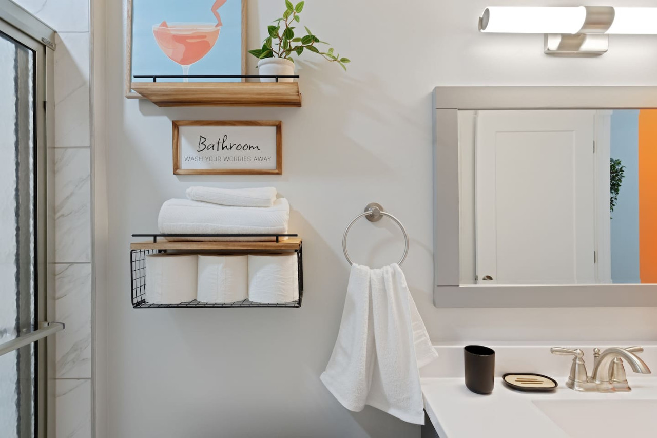 Immaculate bathroom featuring a spacious shower, fresh towels, and complimentary toiletries for a spa-like experience.