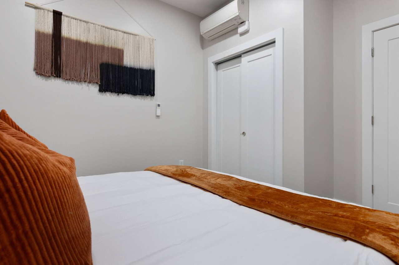 You feel enveloped in comfort as you relax on the queen bed, surrounded by a room designed for tranquility.