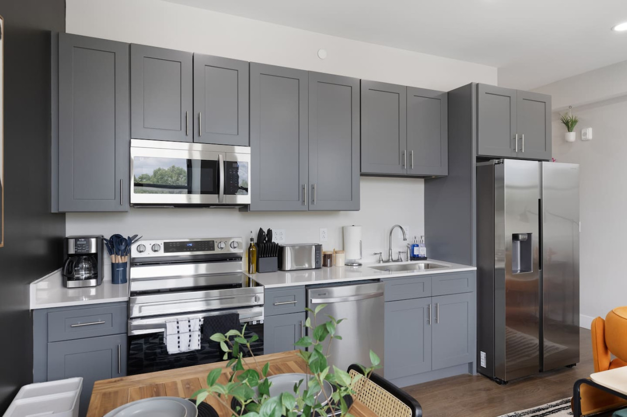 This contemporary kitchen is a chef's dream, featuring a large island, modern stainless steel appliances, and sleek cabinetry. The open layout ensures you can cook and entertain effortlessly, making it the perfect space for culinary creativity and social