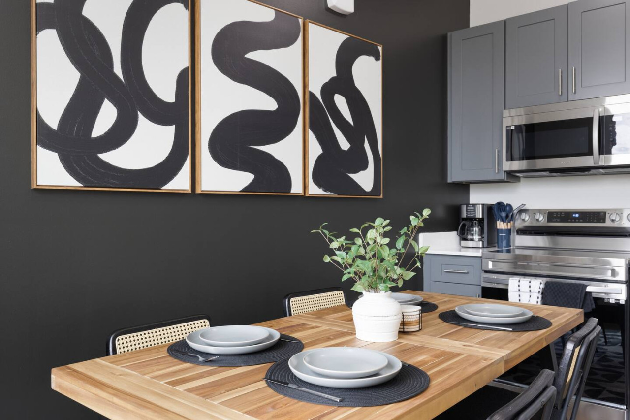 Elegant dining area with a large table and comfortable seating, perfect for gathering with family and friends for a meal.
