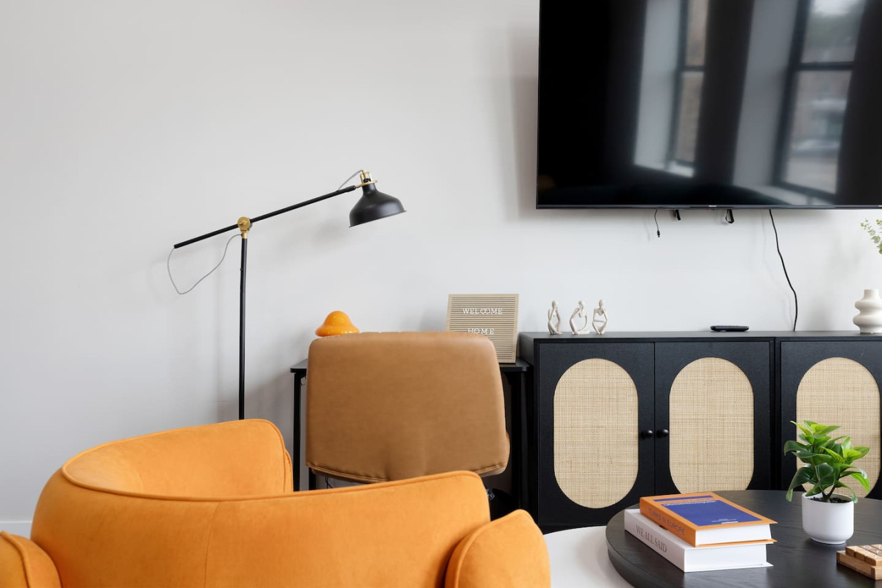 You feel a sense of peace as you step into the living room , with its inviting decor and soothing tones.