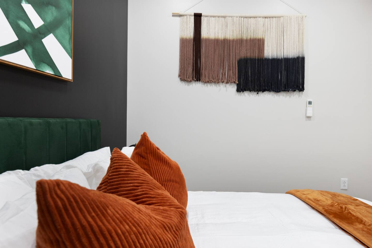 The bedroom offers a luxurious retreat, with a bed that promises restful nights and a room that feels like a private oasis.