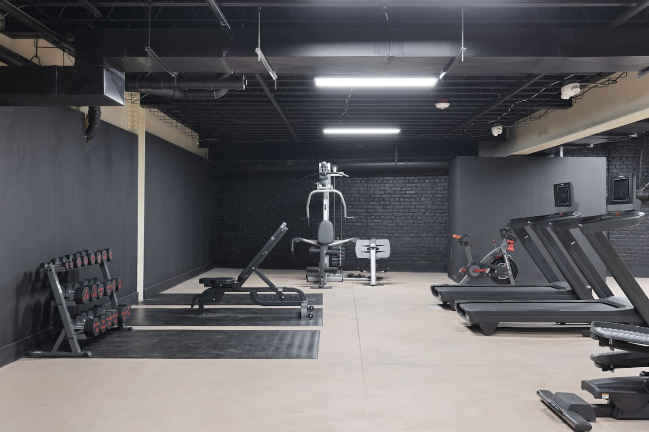 Open floor area with exercise mats, yoga balls, and foam rollers for warm-ups, stretching, or core exercises.