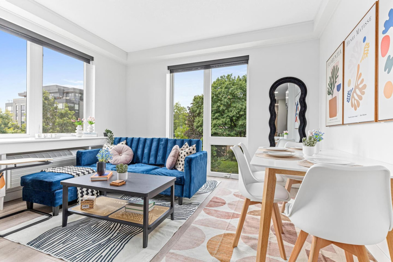 Bright and airy living room with plush seating, a large TV, and tasteful decor, creating the perfect space for relaxation and entertainment.