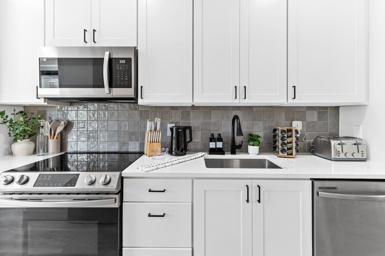 Front hallway - Fully equipped kitchen w/ Stainless steel appliances - Microwave - Dishwasher - Fridge & Freezer - Stove - Sink - Toaster - Spice rack - Kettle - Coffee maker - Knife block - Decorative accents and more.