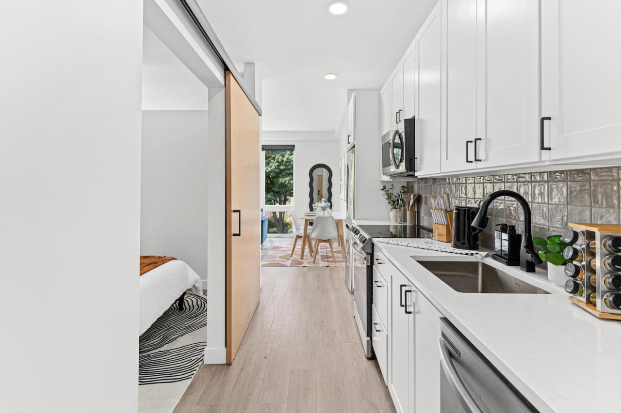 Front hallway - Fully equipped kitchen w/ Stainless steel appliances - Microwave - Dishwasher - Fridge & Freezer - Stove - Sink - Spice rack - Kettle - Coffee maker - Knife block - Decorative accents and more.