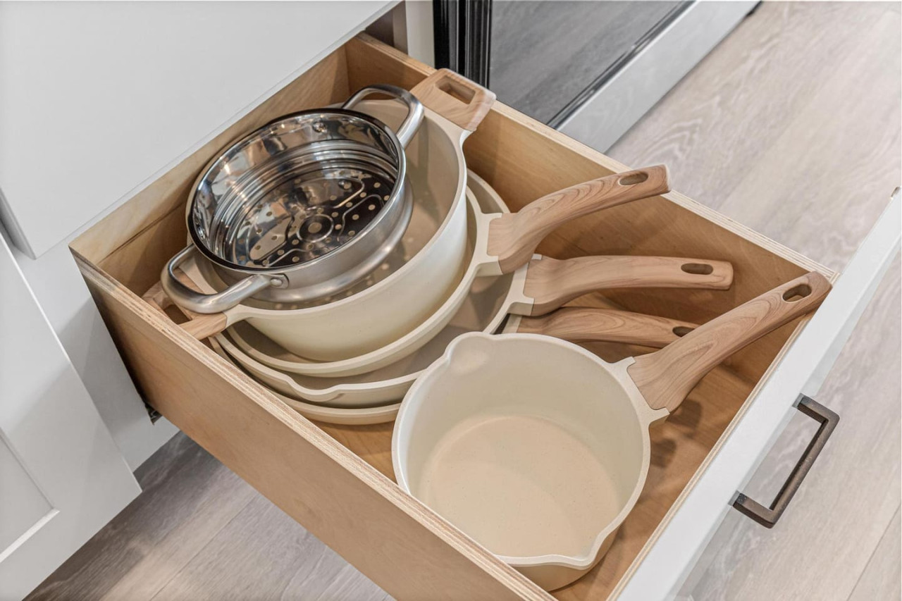 Kitchen drawer full of pots and pans - Strainer.