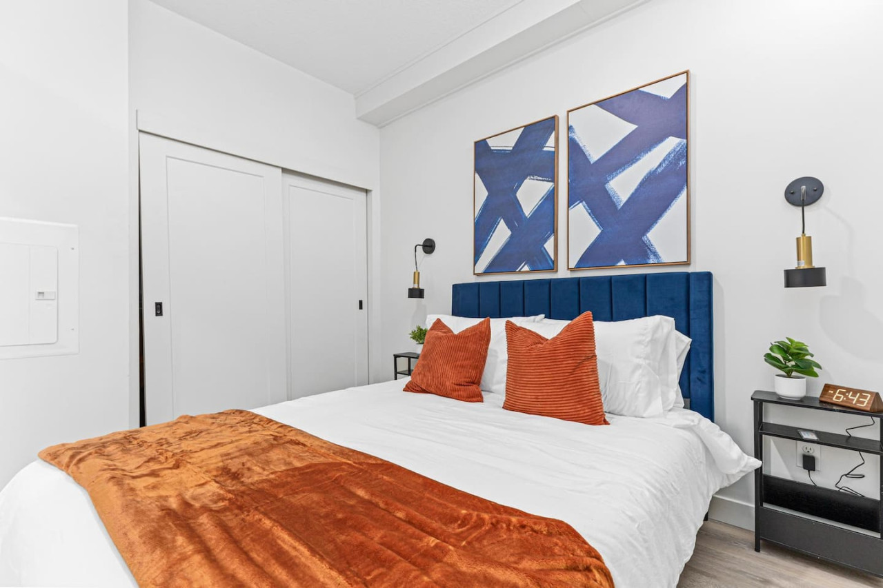 Comfortable Queen size bed - Side tables - Bedside lamps - Wall art - Area rug - Alarm clock, Extra pillows w/ Throw blanket - Full size closet w/ sliding doors.