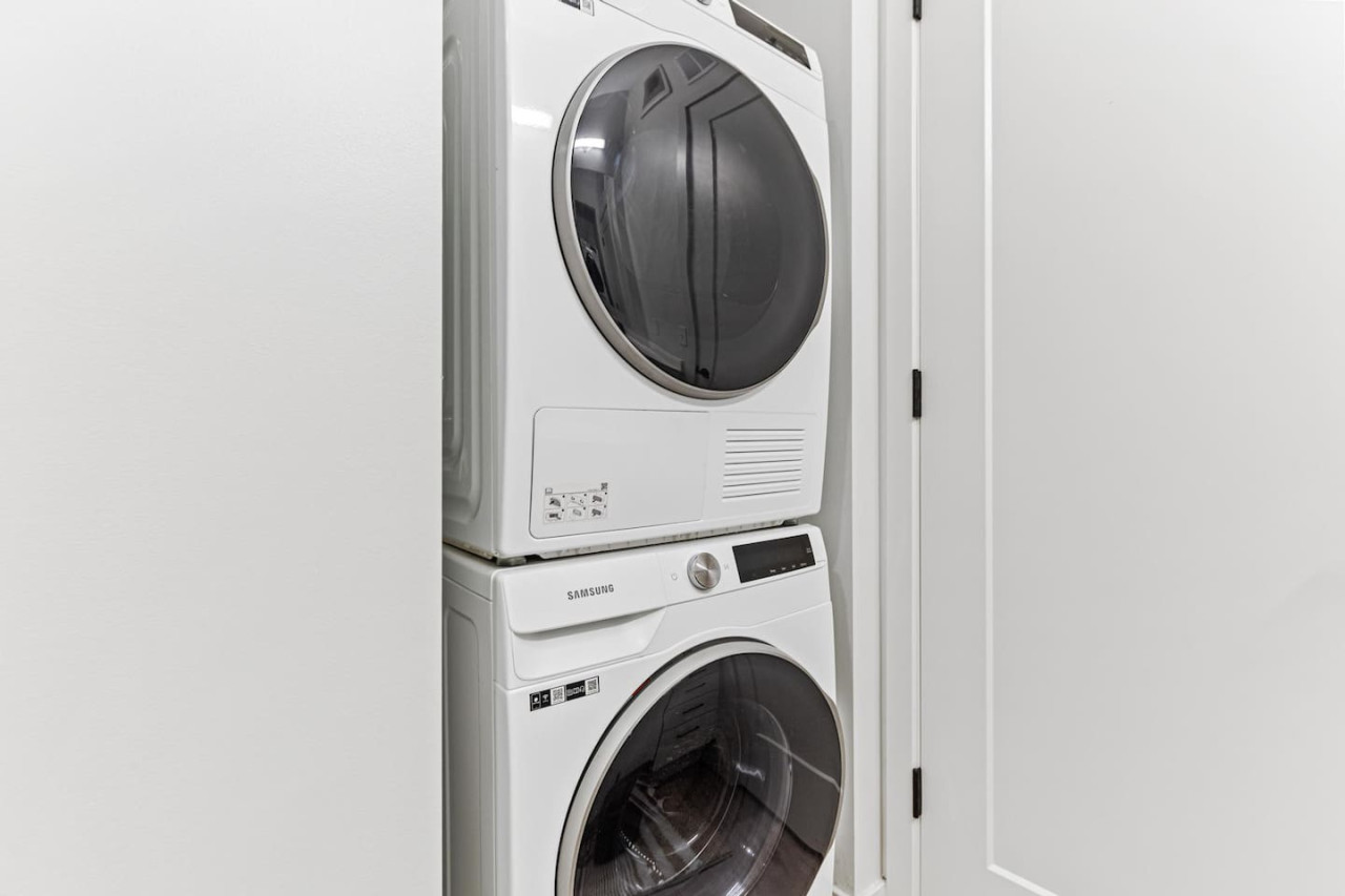 Laundry room with a washer, dryer, and folding area, offering all the convenience you need for a comfortable extended stay.