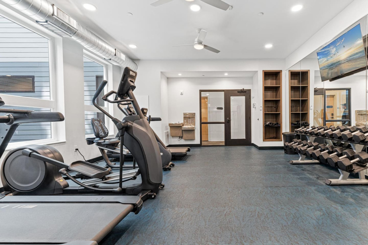 Open floor area with exercise mats, yoga balls, and foam rollers for warm-ups, stretching, or core exercises.