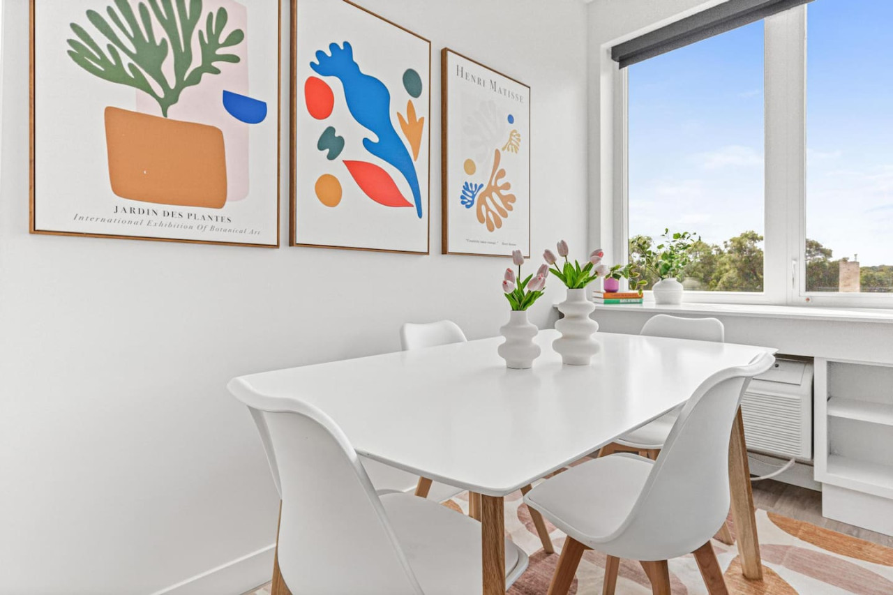Elegant dining area with a large table and comfortable seating, perfect for gathering with family and friends for a meal.